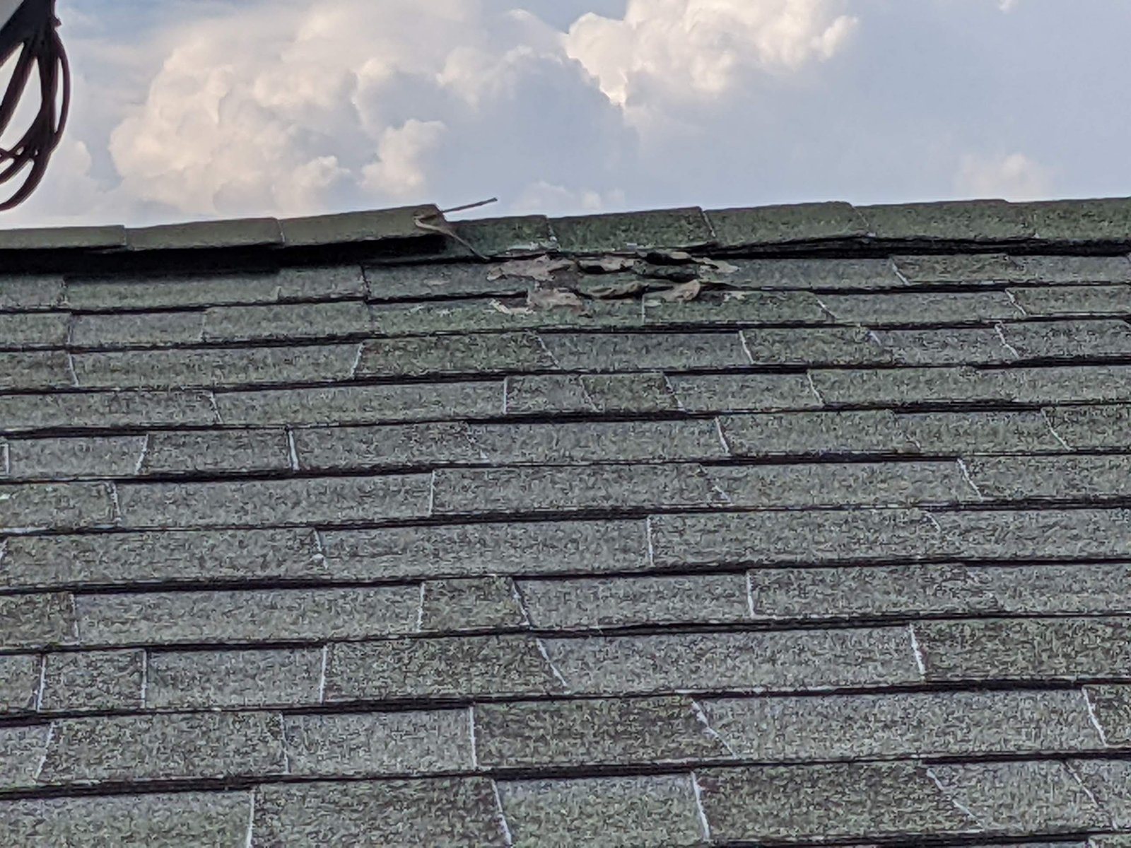 Damaged shingles: torn at the ridge