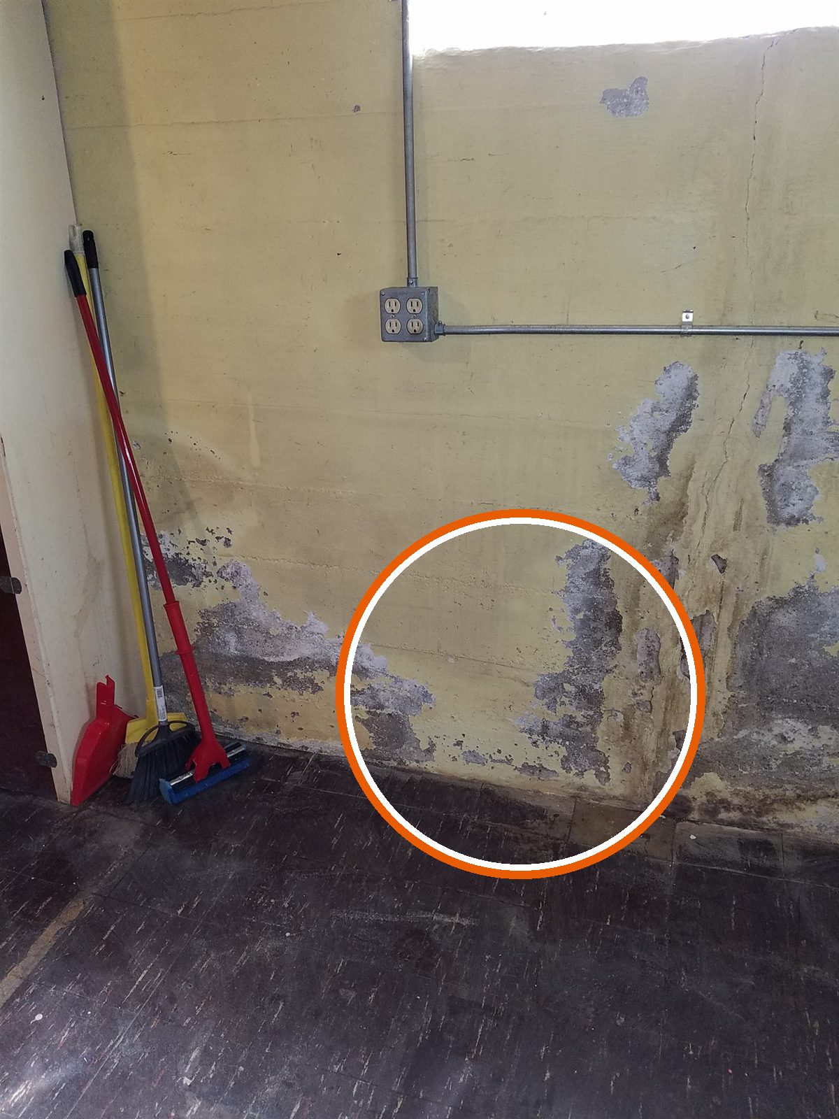Water staining and white mineral deposits on the basement wall