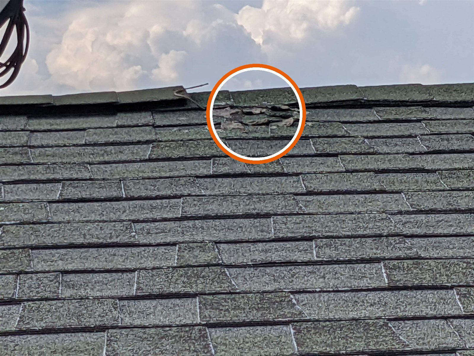 Damaged shingles: torn at the ridge