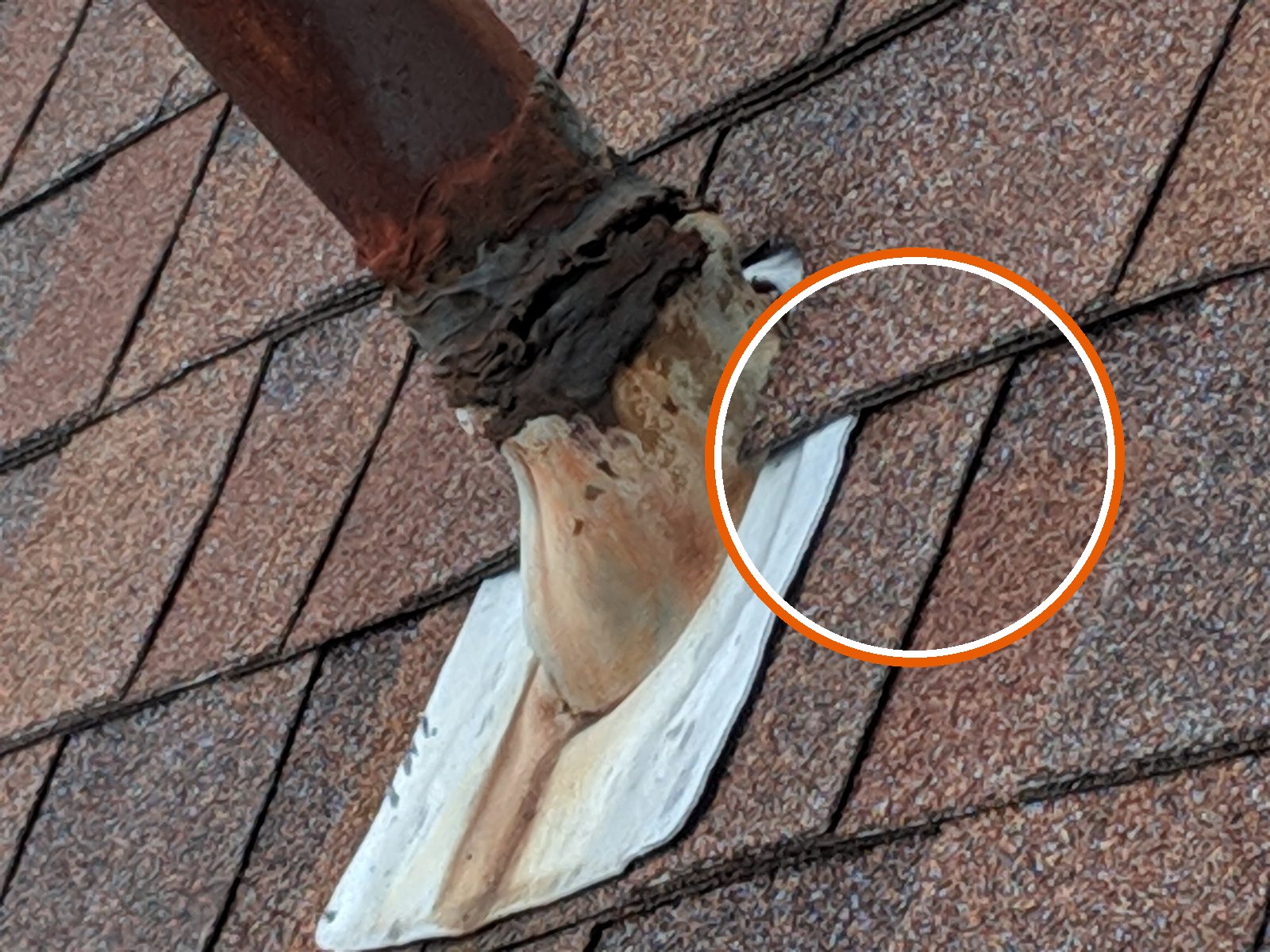 Plumbing vent pipe rusted, boot patched with tar